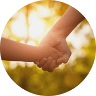 Adult and child holding hands